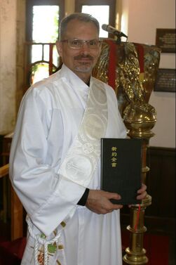 Scott Ellinger with Mandarin Gospel Book